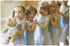 Photo of nursery aged dancers in a line with Melody Bear leading
